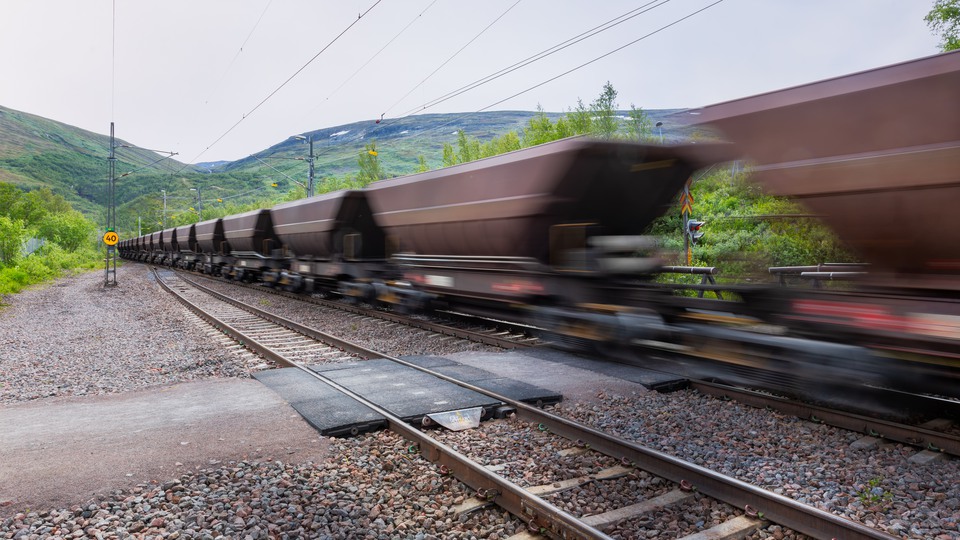 Blurry image of iron ore train in the mountainous landscape of northern Sweden.