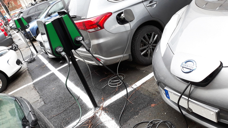 Closeup of electric cars charging at a charging station